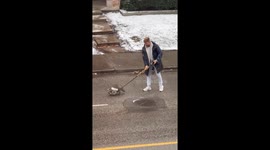Canadian Helps Guide a Raccoon Using a Hockey Stick