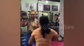 Furious girlfriend storms gym to confront cheating boyfriend with printouts of evidence