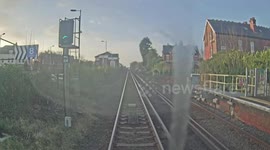Careless pedestrian dodges oncoming train on level crossing in Southport