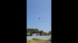 Sudden gust uproots tent sending it flying through the air