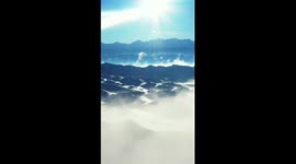 Clouds drift over snow-capped Tianshan Mountains in Xinjiang
