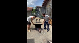 Pair of men drop family's dinner while trying to cook in giant wok