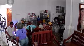 Sweet elderly couple hugs while watching TV