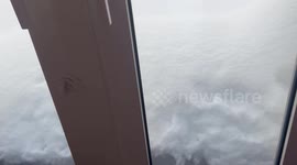 Locals clear thick layers of snow from outside homes in Japan
