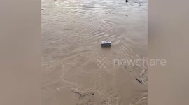 House flows through California river after storm caused a mudslide