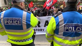 Antifa members being watched by Metropolitan Police officers in Whitehall, London, UK.