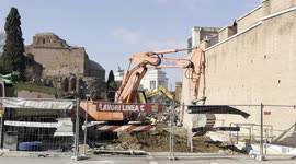 An excavator at work on the construction site for the new Metro C stop near the Colosseum in Rome.