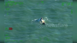 Helicopter rescues three people floating on capsized boat in Florida