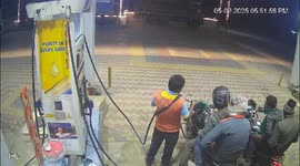 Armed robbers caught on CCTV stealing fuel attendant's money bag
