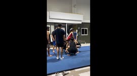Cheerleader KOs team member when she kicks him in face