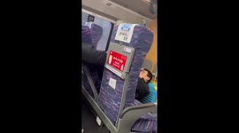 Train passenger causes a stink by putting his dirty feet in the air