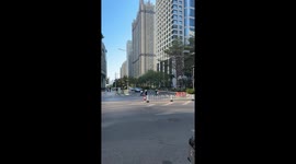Self-pushing baby stroller seen following behind mother