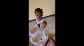 Unexpected playtime twist: Baby girl takes precautions to avoid a puppy toy she fears