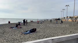 People on the beach of Lido di Ostia on a peaceful sunny day in October in Rome.