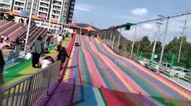 Toddler knocked over by siblings on playground slide