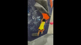Boulder problem at competition wall proves to be difficult, leading to climber’s fall