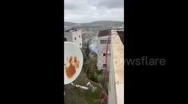 Israeli forces use tear gas on Palestinians during a raid on the village of Burqa east of Ramallah