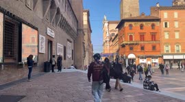 People coming and going in front of the Salaborsa city library near Piazza Maggiore in Bologna.