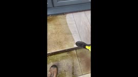 Jet-washing a stairstep with precision during satisfying garden cleaning routine