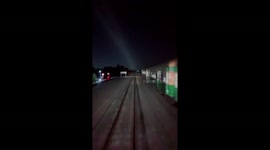 Reckless motorcycle riders speed over level crossing as train approaches