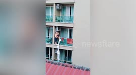 Tourists climb onto balconies to flee hotel fire on Thai island Phuket