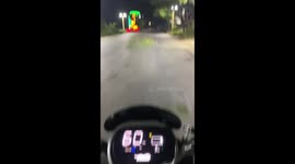 Electric motorcycle rider topples over by a fallen tree branch
