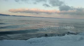 Soft tender waves on the lake. Sunset at the winter. Just to see