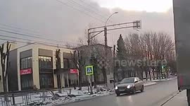 Car hit by oncoming vehicle while turning into side street