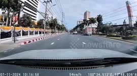 Car crashes into rogue metal barrier rolling across street
