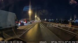 Cars swerve round two people chatting in busy four-lane motorway