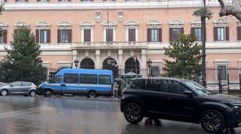 A police van with its flashing lights in front of the American embassy during the Palestine support rally, organized by the Palestinian student movement after Trump's statements near the embassy in Rome.