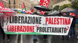 Protesters hold a banner with the slogan ‘from the liberation of Palestine to the liberation of the proletariat’ during the Palestine support rally, organized by the Palestinian student movement in Rome.
