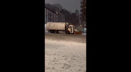 New York snow ploughs clear powder from downtown streets