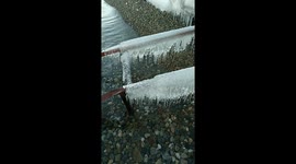 Its pure water of lake Baikal. You can see smallbstouns under water, and some icecles at the bridge for a fishing boat