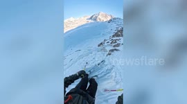 Moment professional skier tears ACL falling down cliff in jump gone wrong