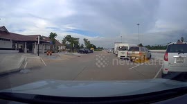 Woman almost hit by car as she runs across road without checking traffic
