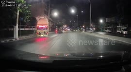 Bus crashes and left 'doing a wheelie' while stuck on power lines in Bangkok