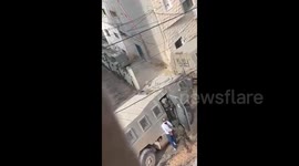 Israeli soldiers detain a Palestinian man during the ongoing assault on the eastern neighborhood of Jenin