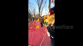 Moment young boy playing ring toss misses prizes and lands perfect shot around owner's neck