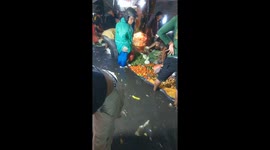 Locals stand in knee-deep floods to go shopping at the market