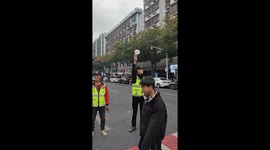 Traffic policeman uses speaker to usher locals across road in China