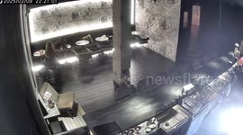 Girl's hair catches fire from candle on bar table as she leans over