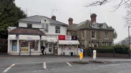 Hero shopkeeper hands over bread, butter and milk to hungry robber with knife