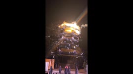 Stunning cold-fireworks waterfall lights up ancient building in China