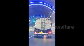 Unique video as truck's ladder shadow sways as if it's dancing in brightly lit tunnel
