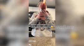 Woman shakes juice bottle and it explodes in her hands
