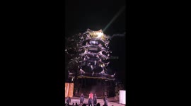 Stunning cold-fireworks waterfall lights up ancient building in China