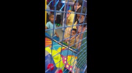 Caring toddler gives his last arcade ball to another kid