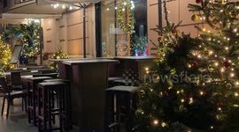 Empty outdoor tables of a restaurant on a cold, windy December evening near the Christmas period in Rome.