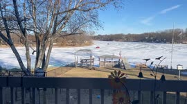 Cars Drive Down Frozen Fox River